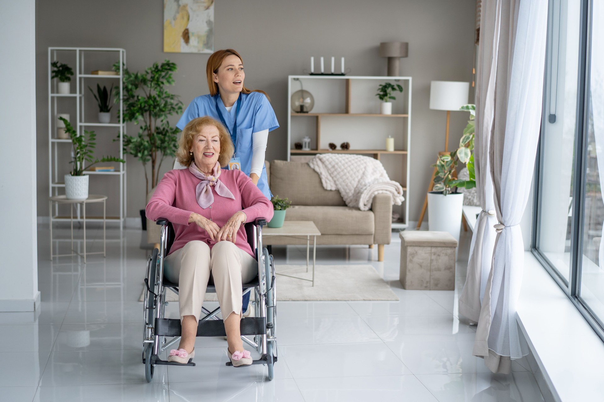 Joyful moment between elderly lady and caring nurse